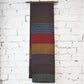 Hanging view of vintage Japanese women's silk textured geometric design Fukuro obi in warm rustic tones.