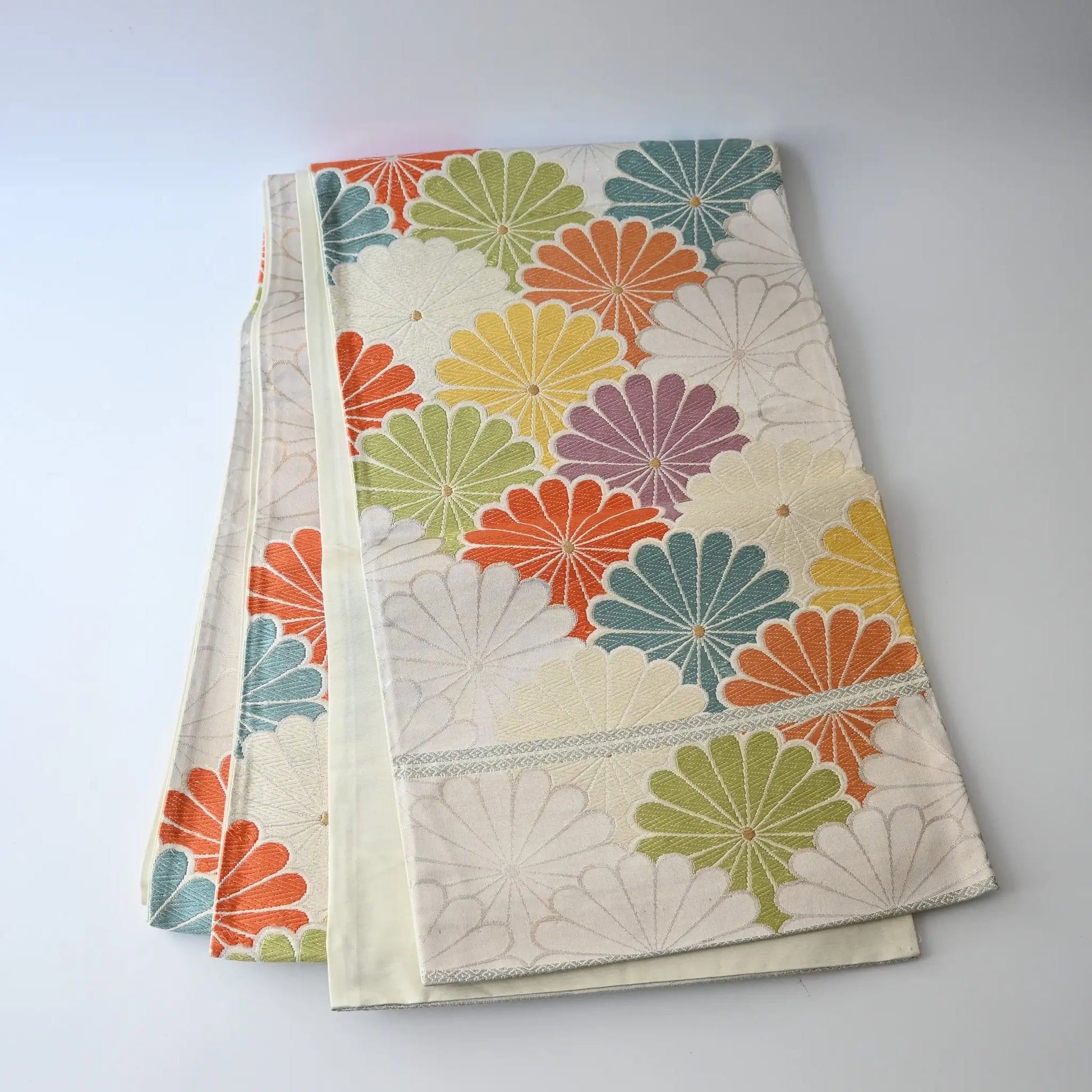 Full view of vintage women's white silk fukuro obi with colourful chrysanthemum motif.