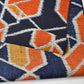 Detailed view of vintage wool kimono fabric in navy and orange with geometric modern pattern.