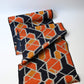 Vintage wool kimono fabric in navy and orange with geometric modern pattern.