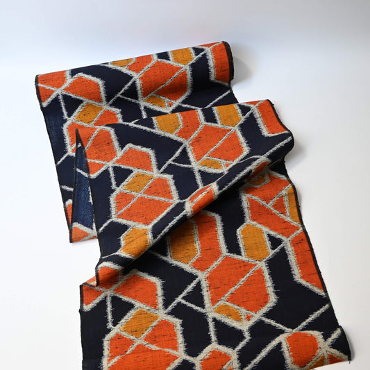 Vintage wool kimono fabric in navy and orange with geometric modern pattern.