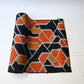 Vintage wool kimono fabric in navy and orange with geometric modern pattern.