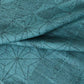 Close-up view of vintage wool and silk blend kimono fabric in turquoise blue with asanoha motif, sold by the metre.