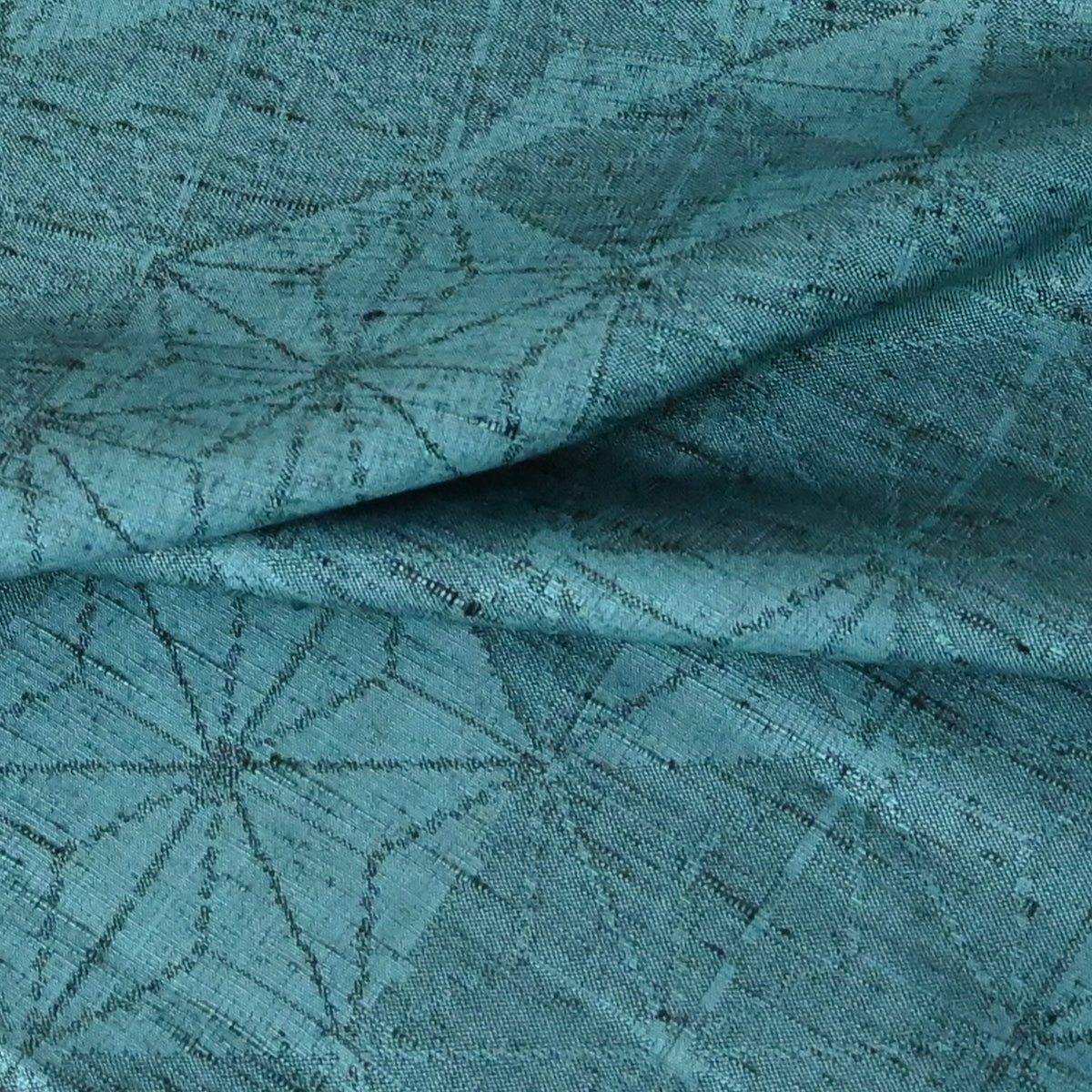Close-up view of vintage wool and silk blend kimono fabric in turquoise blue with asanoha motif, sold by the metre.