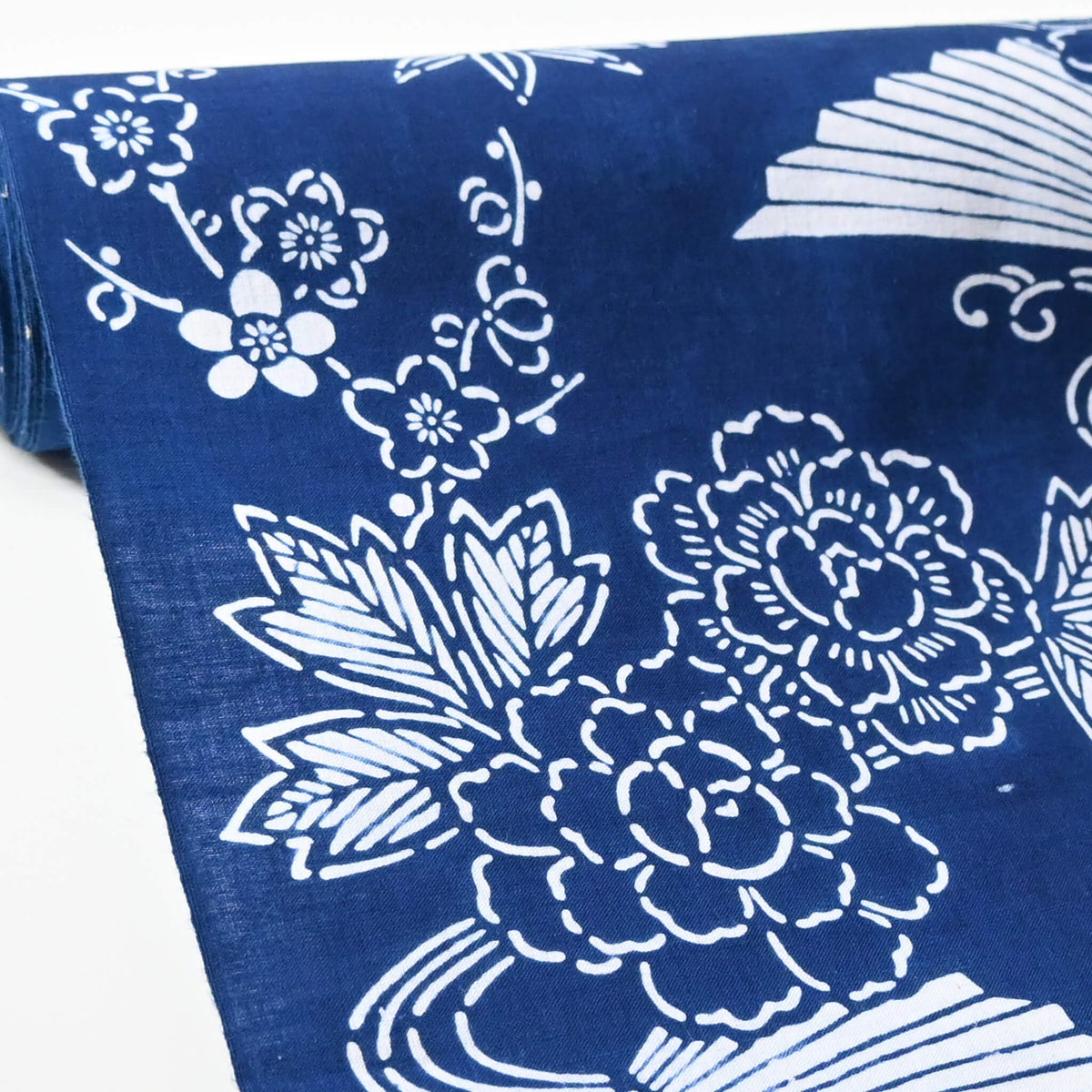 Close-up view of vintage traditional yukata cotton fabric with seasonal flowers, sold by the metre.