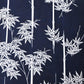 Close-up view of vintage women's yukata cotton fabric with white maple motif on dark indigo base, sold by the metre.